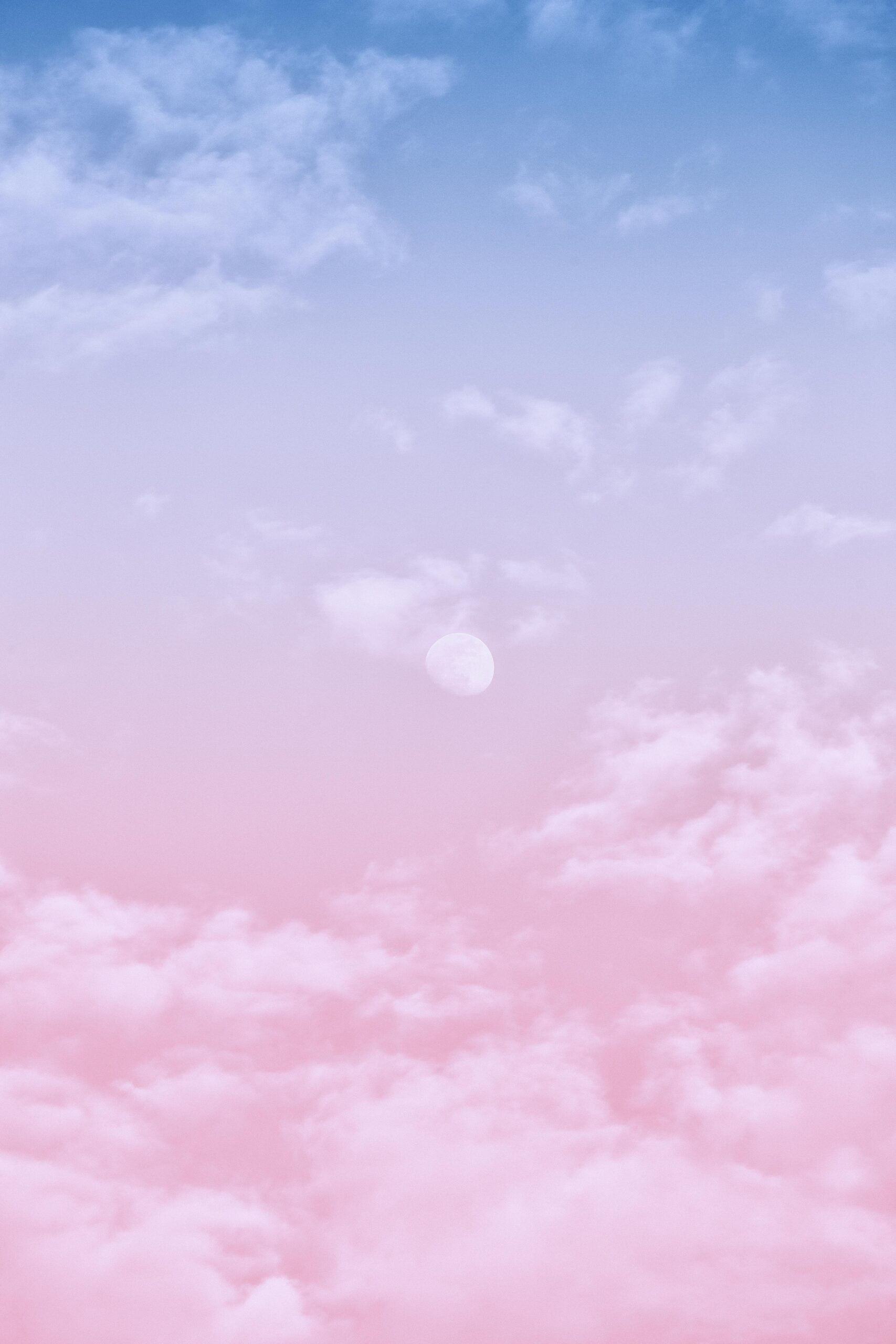 Aesthetic pastel sky with soft clouds and moon, perfect for wallpapers and backgrounds.